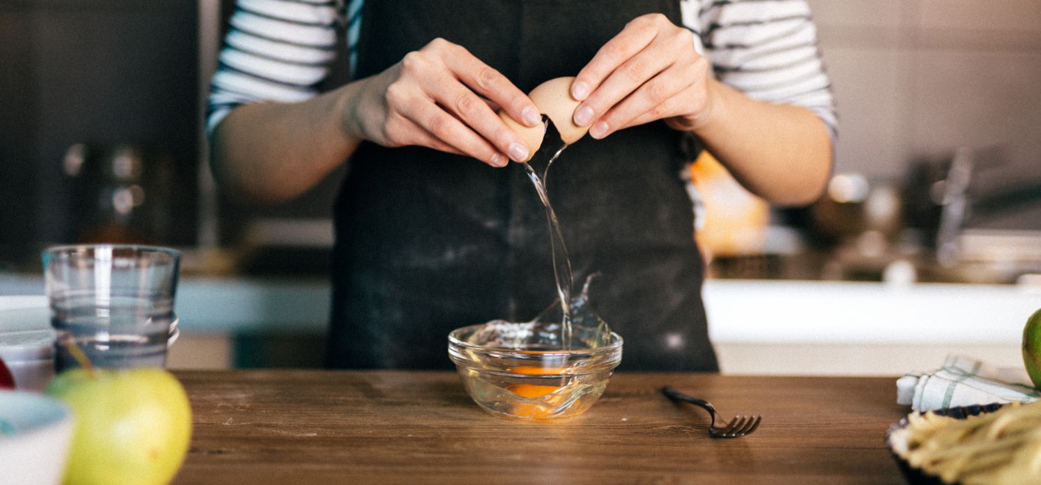 cracking an egg into a bowl