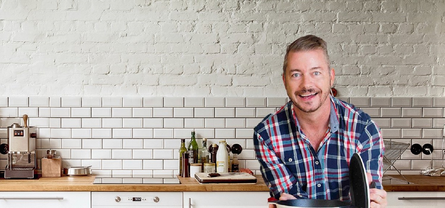 Richard Brogan in kitchen smiling at camera